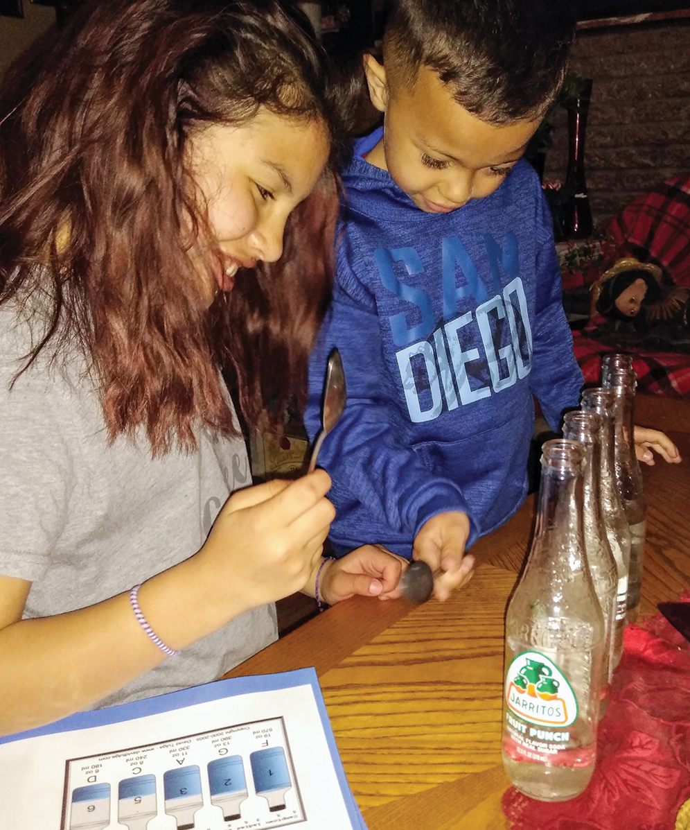 Children examine items from the activity.