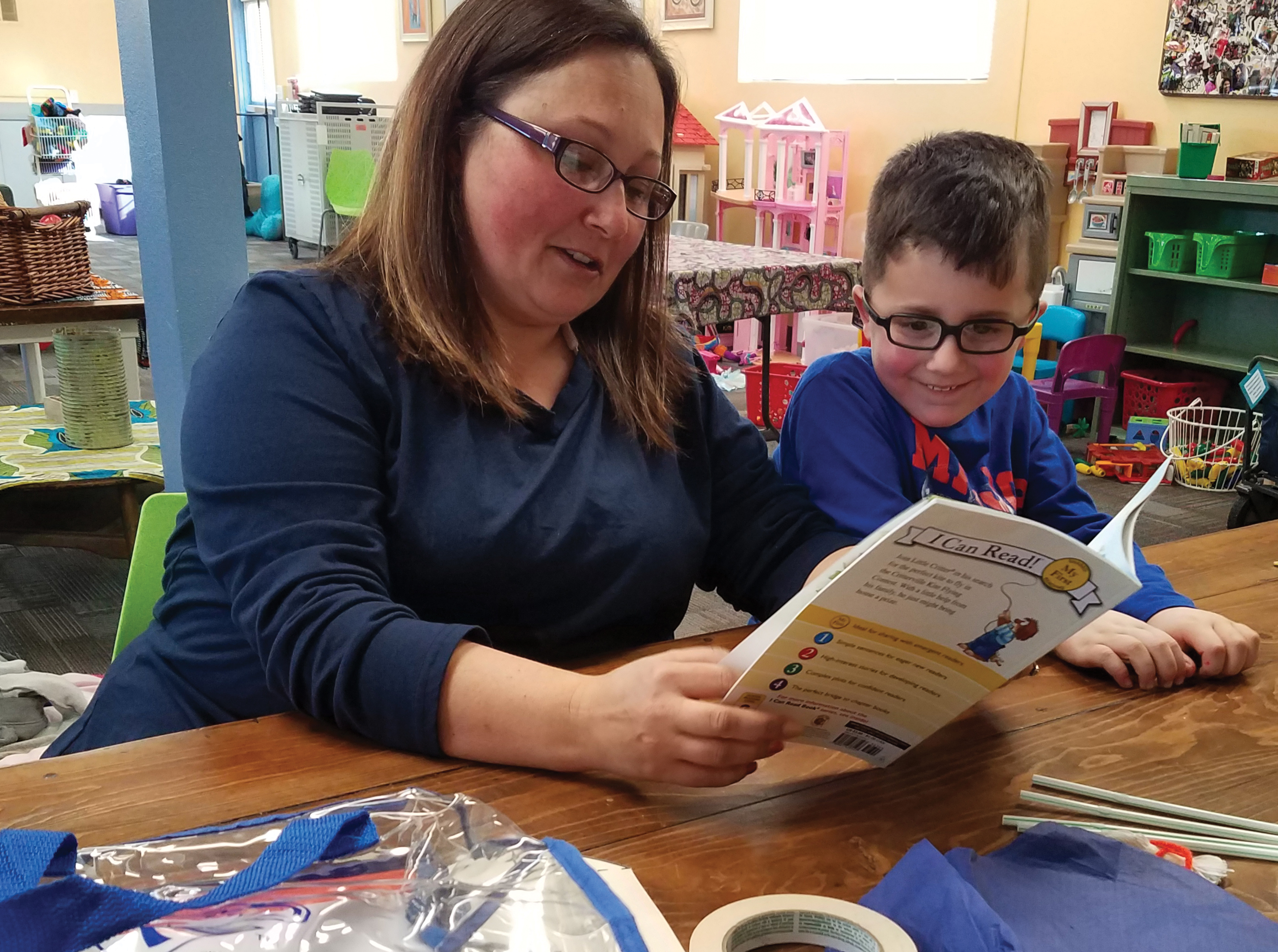 A parent previews a book from the pack.