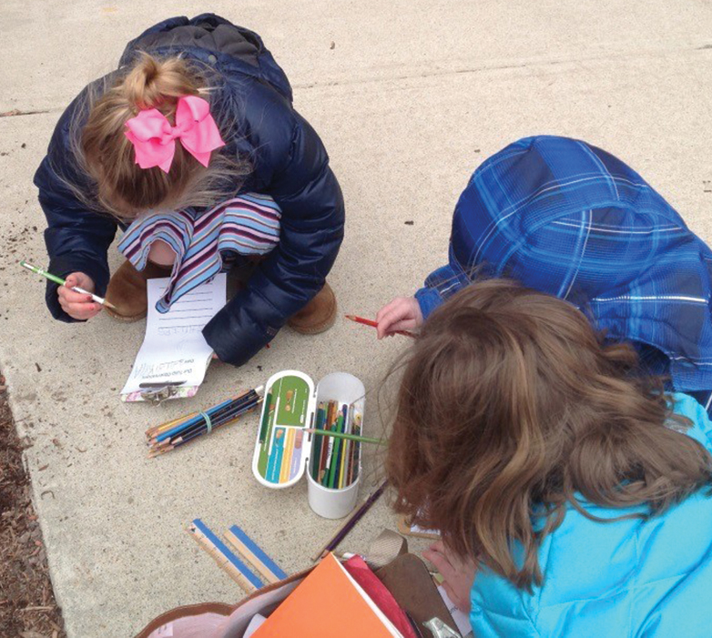 Students draw and write about their bulbs.