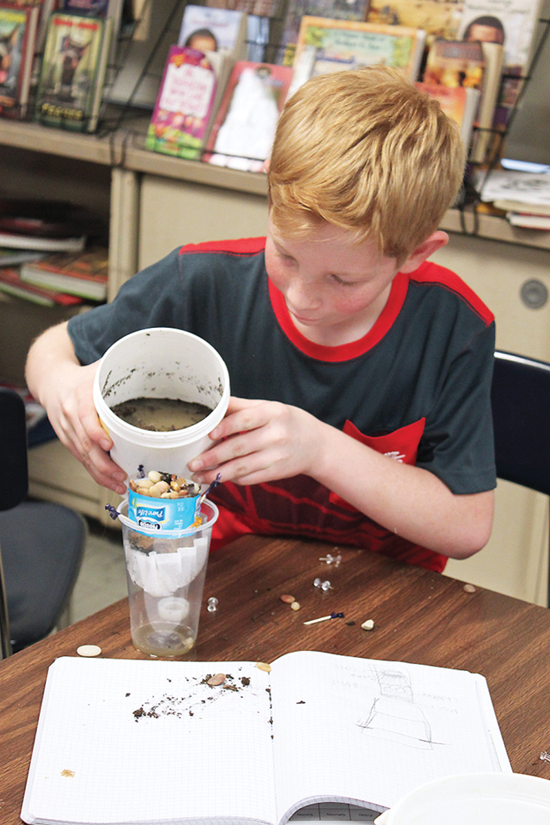 As part of the design process, students test different materials for their water filters.
