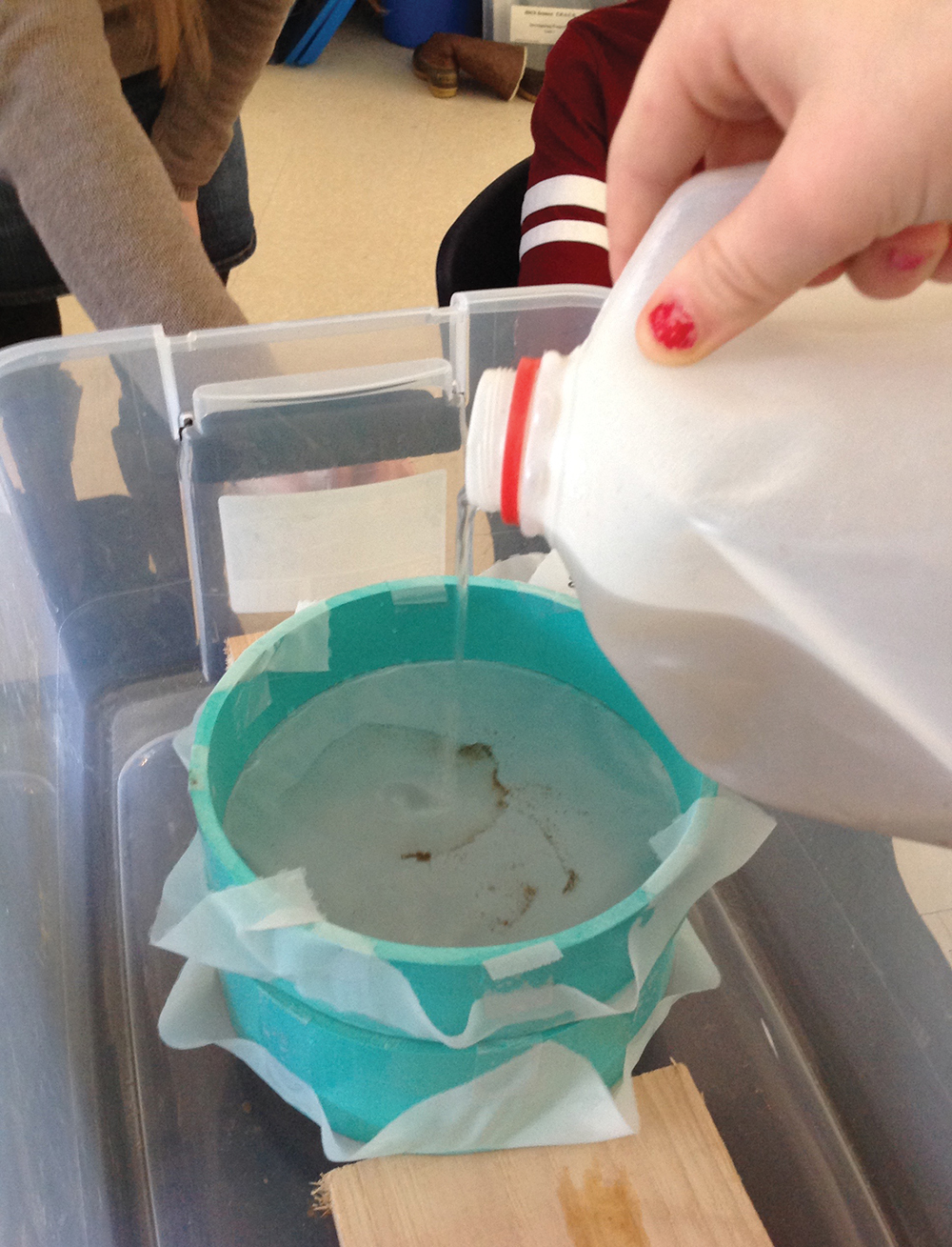 Students filter the water samples through sieves