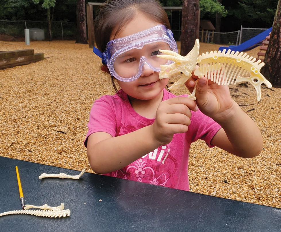 A learner articulates bones on her model.